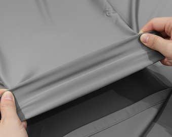 Tela de nailon y elastano gris, de 147 cm de ancho con elasticidad en cuatro direcciones, ideal para trajes de baño y disfraces.