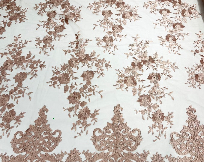 Blush pink  flowers flat lace embroider on a 2 way stretch mesh sold by the yard.