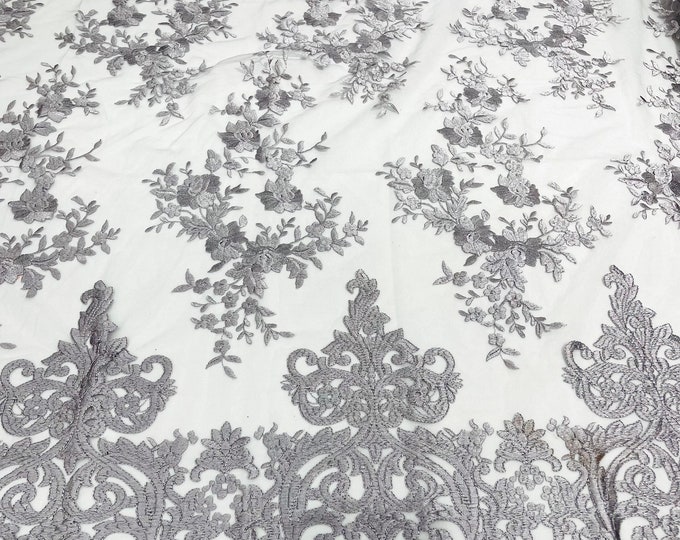 Silver flowers flat lace embroider on a 2 way stretch mesh sold by the yard.
