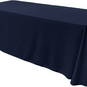 May include: A dark blue rectangular tablecloth. The tablecloth is made of a smooth, wrinkle-resistant fabric.