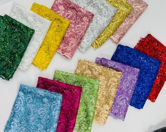 Metallic corded lace design embroidered with holographic sequins on a mesh 54” wide.