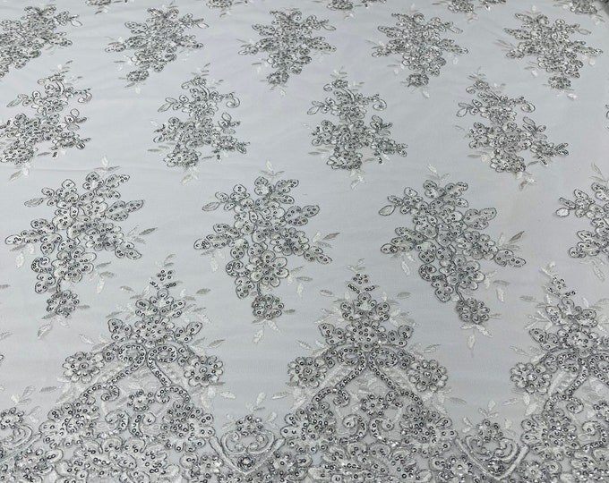 Metallic White flower lace corded and embroider with sequins on a mesh-Sold by the yard.