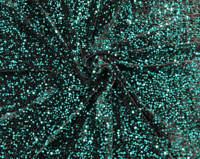 Teal Green economic all over shiny sequins on a 2 way stretch black velvet , sold by the yard.