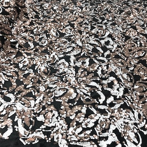 Rose gold, white sequins flip two tone floral design on a black stretch velvet, Sold by the yard.