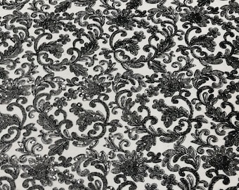 Black metallic corded embroider flowers with sequins on a mesh lace fabric-prom-sold by the yard.