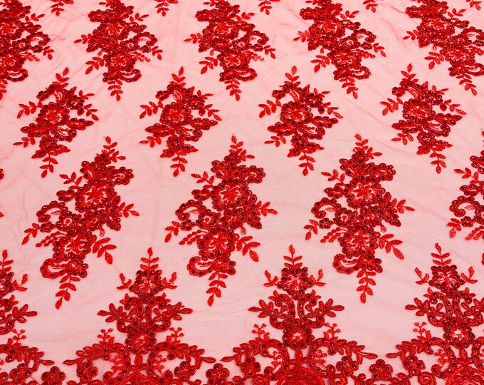 Red corded flowers embroider with sequins on a mesh lace fabric-sold by the yard.