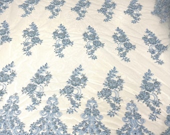 Light Blue elegant hand beaded flower design embroider on a mesh lace-prom-sold by the yard.