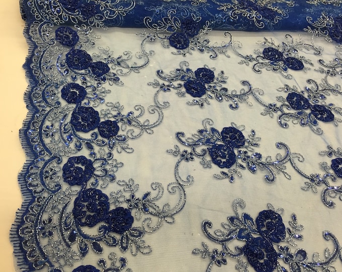 Royal blue/silver 3d flowers embroider with sequins on a royal blue mesh lace. Wedding/bridal/prom/nightgown fabric. Sold by the yard.