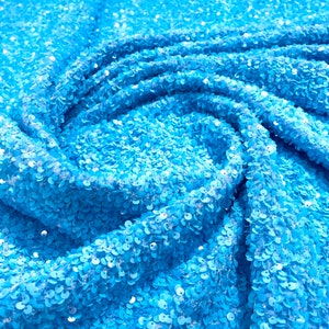 Turquoise 5mm sequins on a blue stretch velvet 2-way stretch, sold by the yard.