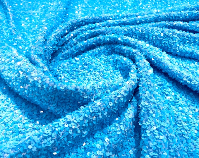 Turquoise 5mm sequins on a blue stretch velvet 2-way stretch, sold by the yard.