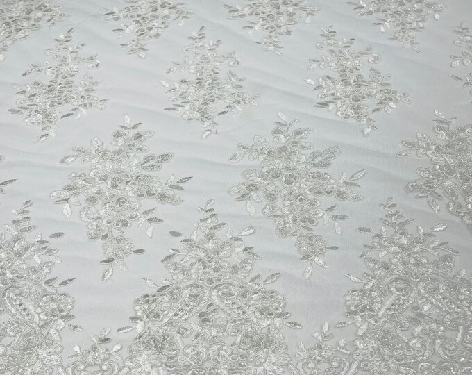 White flower lace corded and embroider with sequins on a mesh-Sold by the yard.