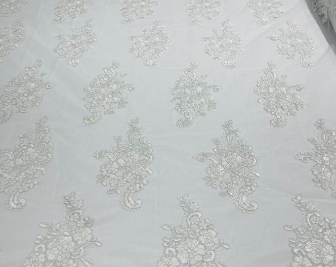 White flower lace corded and embroider with sequins on a mesh-Sold by the yard.