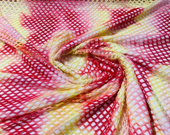 Red/Yellow big fishnet diamond mesh tie dye with silver glitter 4 way stretch 58/60 inches wide. Sold by the yard.