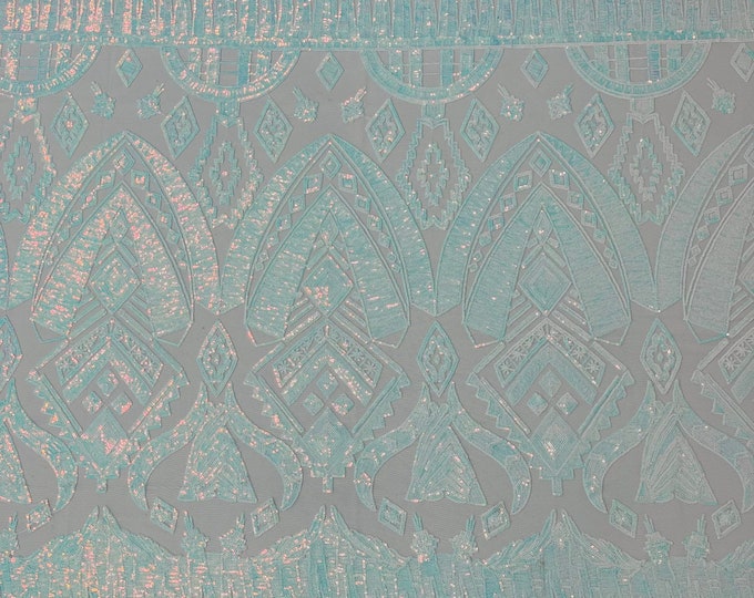 Clear aqua iridescent geometric Aztec  design embroidery with sequins on a White 4 way stretch mesh fabric-sold by the yard.