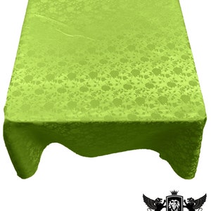 May include: A lime green tablecloth with a floral pattern. The tablecloth is made of a satin-like material and has a slight sheen.