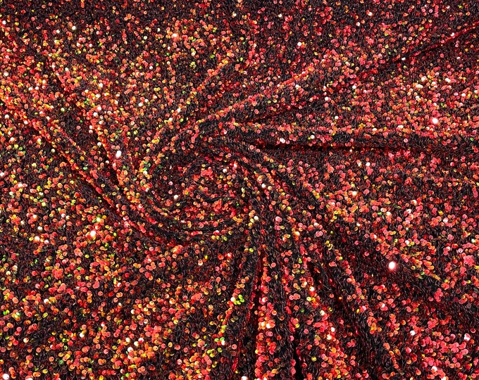 Red /orange 5mm sequins on a black stretch velvet 2-way stretch, sold by the yard.