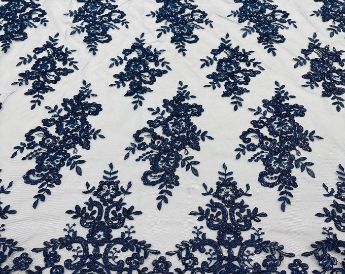 Navy blue corded flowers embroider with sequins on a mesh lace fabric-sold by the yard.