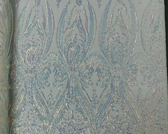 Aqua iridescent empire damask design with clear sequins embroider on a White 4 way stretch mesh fabric-sold by the yard.