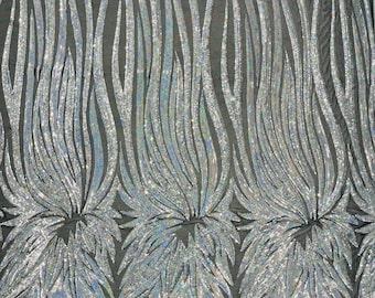 Silver Holographic sequin Wings design on a black 4 way stretch mesh fabric- prom-nightgown-by the yard-free shipping in the USA.
