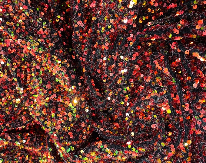 Orange/Green Iridescent Sequins all over a Black Stretch Velvet , Sold by the yard.