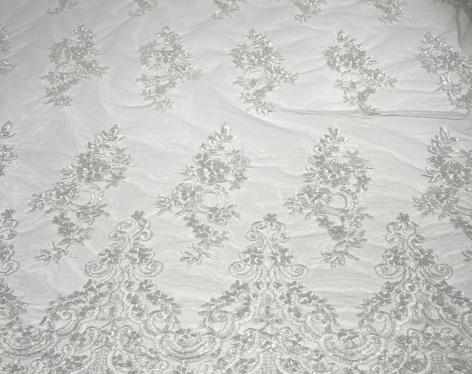 White elegant hand beaded flower design embroider on a mesh lace-prom-sold by the yard.