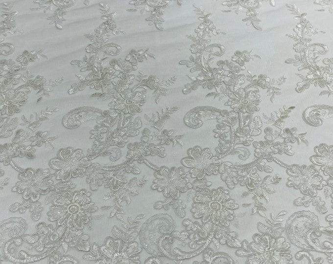 White Gomez Floral design corded embroider with sequins on a mesh lace fabric-sold by the yard.