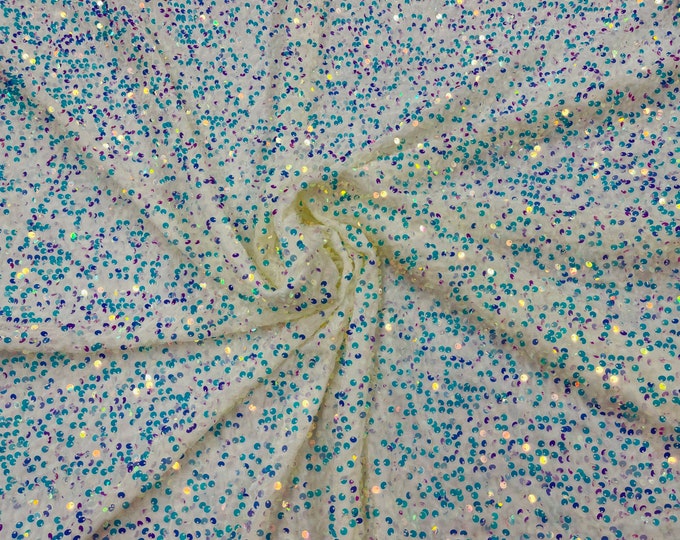 Clear Iridescent economic all over shiny sequins on a 2 way stretch White velvet , sold by the yard.