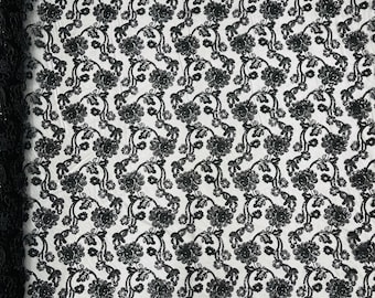 Black corded flowers embroider with sequins on a mesh lace fabric-prom-sold by the yard.