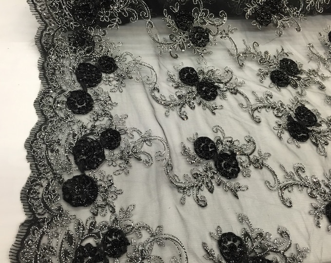 Black/silver 3d flowers embroider with sequins on a black mesh lace. Wedding/bridal/prom/nightgown fabric. Sold by the yard.