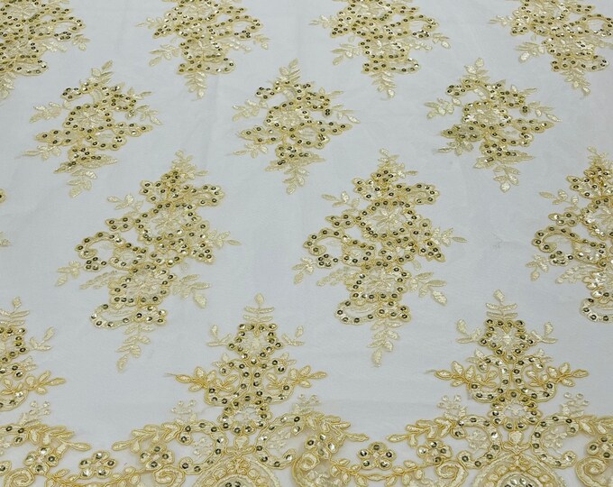 Banana yellow corded flowers embroider with sequins on a mesh lace fabric-sold by the yard.