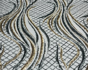 Gold/Silver sequin flame design on a 4 way stretch silver mesh-sold by the yard.
