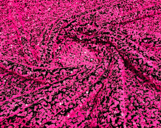 Neon pink  5mm sequins on a black stretch velvet 2-way stretch, sold by the yard.