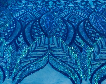 Turquoise iridescent royalty sequin design on blue 4 way stretch mesh-prom-sold by the yard.
