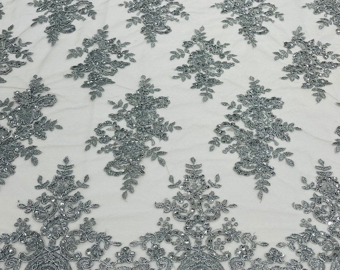 Gray corded flowers embroider with sequins on a mesh lace fabric-sold by the yard.