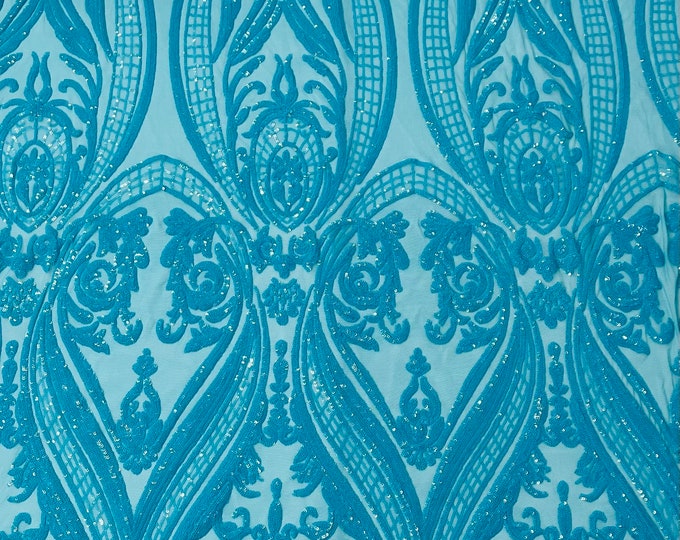 Turquoise empire design embroider with glossy sequins on a 4 way stretch mesh--sold by the yard.NEW!