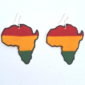 May include: A pair of earrings in the shape of Africa. The earrings are coloured red, yellow, and green, with a black outline. They hang from silver-coloured hooks.