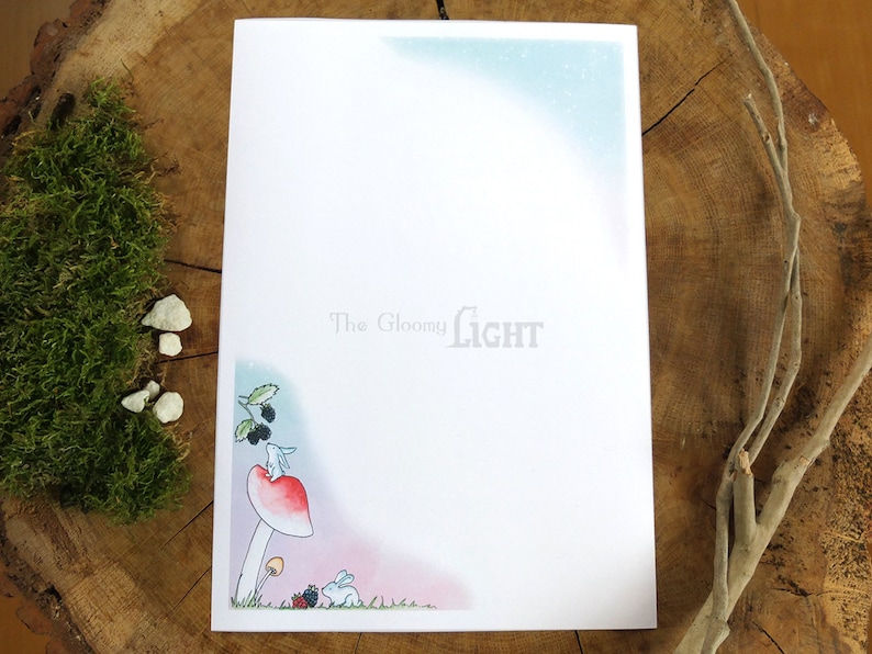 May include: A white rabbit sits on a red mushroom with a white stem. The mushroom is in a forest setting with green leaves and blackberries. The text "The Gloomy Light" is at the top of the page.