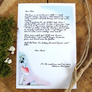 May include: A handwritten letter with blue watercolor background and a whimsical illustration of a mushroom, a rabbit, and a blackberry bush. The letter reads, "Dear Race, Thank you so much for your letter! (really enjoyed reading about your latest adventures (hope mine were a bit entertaining (but surely not as exciting). I have to apologize for my belated reply. Since I started at this new place, I've been very busy (even forgot to do the grocery shopping a few times and I ended up eating cereal for dinner! But it's been an amazing experience so far. I will tell you all about it when we're meeting next month. Three more weeks and I'd fly over to your Wonderland, I can't wait to see you in person again, and drink some tea together. Until that time, I'm looking forward to your next letter. Love, Lovis P.S. The sweets you sent me were delicious, thank you!"