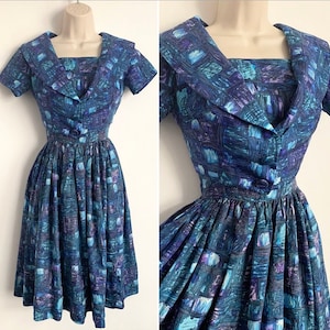 May include: A blue and purple patterned dress with a wide collar and a fitted bodice. The dress has a full skirt and is made of a lightweight fabric.