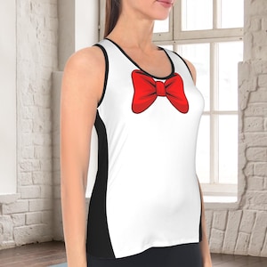May include: A sleeveless tank top featuring a white front panel with a large, bright red graphic bow tie printed at the neckline. The garment includes black side panels and black trim along the armholes and the round neckline, creating a contrast.