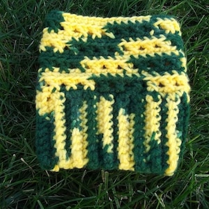 May include: Green and yellow crocheted leg warmers. The leg warmers are made with a striped pattern.