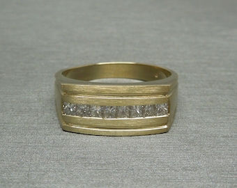 May include: A gold band ring with a row of small, clear diamonds set in the center.