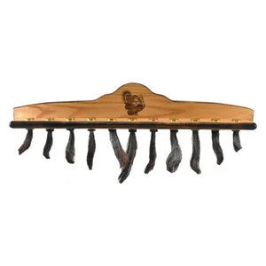 May include: A wooden turkey tail fan holder with a turkey silhouette and 12 hooks for storing turkey tail fans. The holder is made of oak wood and has a dark brown stain.