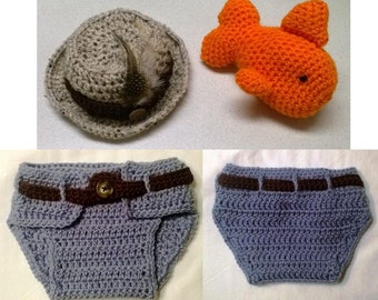 May include: A crocheted baby outfit set with a gray hat, a gray diaper with a brown belt, and an orange fish.