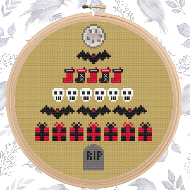 May include: A cross-stitch design in a wooden hoop features a Halloween-themed tree. The tree is composed of bats, stockings, skulls, gifts, and a tombstone with "RIP" on it. The design is stitched on a tan fabric.