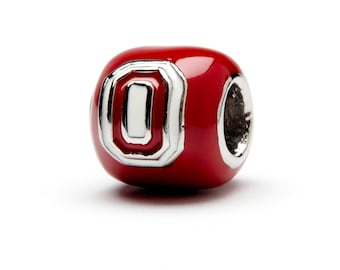 May include: A red and silver charm bead with the letter "O" in a white and silver design. The bead is a popular college sports team logo.
