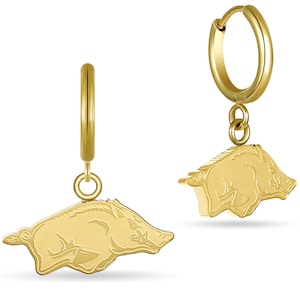 May include: A pair of gold hoop earrings with a dangling charm of a stylized running wild hog.