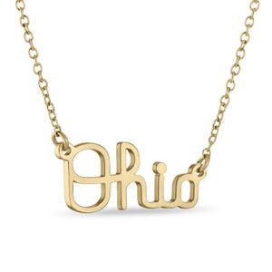 May include: Gold necklace with the word "Ohio" spelled out in a cursive font.