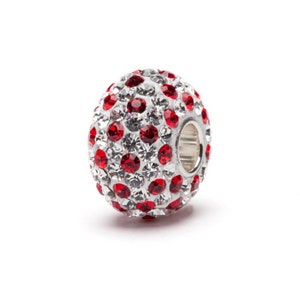 May include: A silver charm bead with a round shape, covered in small red and clear crystals.