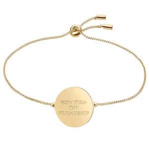 May include: Gold adjustable bracelet with a round charm that says "How Firm Thy Friendship".